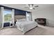 Stylish bedroom featuring a blue accent wall, large bed, and a cozy crib, perfect for a Gathering at 159 Wood Orchid Ln, Garner, NC 27529