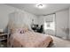 Bright bedroom with a cozy bed, workstation, and lots of natural light streaming through the window at 159 Wood Orchid Ln, Garner, NC 27529