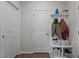 Functional entryway with coat hooks, storage shelves, and hardwood flooring at 159 Wood Orchid Ln, Garner, NC 27529