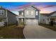 Charming two-story home featuring blue siding, white trim, a two-car garage, and manicured landscaping at 159 Wood Orchid Ln, Garner, NC 27529