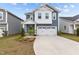 Charming two-story home featuring blue siding, white trim, a two-car garage, and manicured landscaping at 159 Wood Orchid Ln, Garner, NC 27529