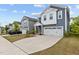 Charming two-story home boasts a two-car garage, well-manicured lawn, and inviting curb appeal at 159 Wood Orchid Ln, Garner, NC 27529