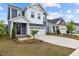 Traditional home with a well-maintained lawn, manicured shrubs, and a two-car garage at 159 Wood Orchid Ln, Garner, NC 27529