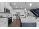 Well-lit kitchen with stainless appliances, white cabinetry, and spacious countertops at 159 Wood Orchid Ln, Garner, NC 27529