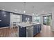 Stylish kitchen island with stainless steel appliances, sink, and hardwood floors at 159 Wood Orchid Ln, Garner, NC 27529
