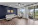 Cozy living room featuring hardwood floors, a ceiling fan, and a screened-in porch view at 159 Wood Orchid Ln, Garner, NC 27529