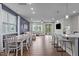 Spacious open-concept living area with hardwood floors, dining table, and modern white kitchen at 159 Wood Orchid Ln, Garner, NC 27529
