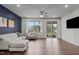 Bright living room with hardwood floors, comfortable seating, and natural light at 159 Wood Orchid Ln, Garner, NC 27529