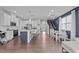 Bright, open-concept living area featuring a modern kitchen with stainless steel appliances at 159 Wood Orchid Ln, Garner, NC 27529