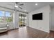 Airy living room with ceiling fan, hardwood floors, and view of an outdoor patio at 159 Wood Orchid Ln, Garner, NC 27529