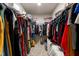 Organized walk-in closet with hanging racks and shelving for maximizing storage space and convenience at 159 Wood Orchid Ln, Garner, NC 27529