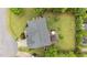 Aerial view of a home's roof, backyard with a wood deck and umbrella and mature trees at 19 Arch Oak Ct, Clayton, NC 27527