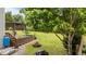 Beautifully landscaped backyard complete with a custom fire pit and wooden deck with shade at 19 Arch Oak Ct, Clayton, NC 27527