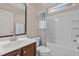 Updated bathroom with a shower-tub combo, white tile, and wood vanity at 19 Arch Oak Ct, Clayton, NC 27527