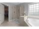 Bathroom featuring a shower and a bathtub with a window at 19 Arch Oak Ct, Clayton, NC 27527