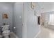 Bathroom showcasing a toilet, vanity, and hallway leading to shower and bathtub area at 19 Arch Oak Ct, Clayton, NC 27527