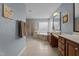 Light-filled bathroom boasts a soaking tub, double vanity, walk-in shower, and neutral tile flooring at 19 Arch Oak Ct, Clayton, NC 27527
