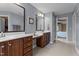 Spacious bathroom with dual vanities, tiled floors, decorative mirrors and a view to the bedroom at 19 Arch Oak Ct, Clayton, NC 27527