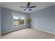 Cozy bedroom with a large window providing natural light and carpeted floors at 19 Arch Oak Ct, Clayton, NC 27527