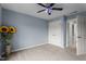 Blue bedroom with plush carpet, a ceiling fan, and a double closet at 19 Arch Oak Ct, Clayton, NC 27527