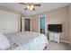 This bedroom has neutral walls and a nautical theme bedspread with an ensuite bathroom at 19 Arch Oak Ct, Clayton, NC 27527