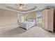 Bright and airy bedroom boasts a tray ceiling and large windows that offer plenty of natural light at 19 Arch Oak Ct, Clayton, NC 27527