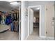 Walk-in closet with white wire shelving and access to a bathroom and an additional closet at 19 Arch Oak Ct, Clayton, NC 27527