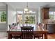 Bright dining area featuring hardwood floors, chandelier, and view of backyard at 19 Arch Oak Ct, Clayton, NC 27527