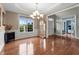Formal dining room featuring wainscoting, hardwood floors, chandelier, and a large window with blind at 19 Arch Oak Ct, Clayton, NC 27527