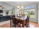 Open-concept dining area with hardwood floors, view of the living room and backyard at 19 Arch Oak Ct, Clayton, NC 27527