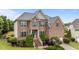 Charming brick home featuring a well-manicured lawn and inviting front entrance with blue door and shutters at 19 Arch Oak Ct, Clayton, NC 27527