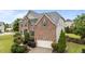 Charming brick home featuring a well-manicured lawn and inviting front entrance with blue door and shutters at 19 Arch Oak Ct, Clayton, NC 27527