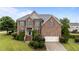 Charming brick home featuring a well-manicured lawn and inviting front entrance with blue door and shutters at 19 Arch Oak Ct, Clayton, NC 27527