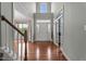 Bright foyer features hardwood floors, high ceilings, and decorative glass accents on the front door and sidelight windows at 19 Arch Oak Ct, Clayton, NC 27527