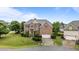 Stately two-story brick home with a well-manicured front lawn, attached garage, and inviting curb appeal at 19 Arch Oak Ct, Clayton, NC 27527