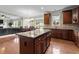 Open-concept kitchen with island, hardwood floors, and view of the dining and living areas at 19 Arch Oak Ct, Clayton, NC 27527