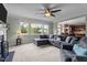 Comfortable living room featuring a large sectional sofa, fireplace, and plenty of natural light from large windows at 19 Arch Oak Ct, Clayton, NC 27527