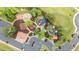 Birds eye view of a colorful playground with various play structures, safe surfaces, and convenient parking for families at 19 Arch Oak Ct, Clayton, NC 27527