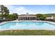 Community pool featuring clear water, plenty of lounge chairs, umbrellas and a clubhouse at 19 Arch Oak Ct, Clayton, NC 27527