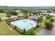 Aerial view of a large community pool with lounge chairs and umbrellas at 19 Arch Oak Ct, Clayton, NC 27527