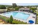 Community pool featuring plenty of lounge chairs, umbrellas, and a clubhouse at 19 Arch Oak Ct, Clayton, NC 27527