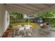 Backyard patio featuring a table with chairs, storage shed, and grill at 1915 James St, Durham, NC 27707