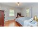 Cozy bedroom featuring hardwood floors, natural light, and neutral paint at 1915 James St, Durham, NC 27707