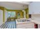 Eat-in kitchen with stainless steel sink, checkered floors, and bright green painted walls at 1915 James St, Durham, NC 27707