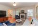 Cozy living room with fireplace, hardwood floors, and lots of natural light at 1915 James St, Durham, NC 27707