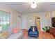 Bright living room with lots of natural light, hardwood floors, and neutral paint at 1915 James St, Durham, NC 27707