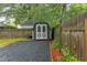 Backyard storage shed with gray gravel and wooden border at 1915 James St, Durham, NC 27707
