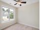 Bedroom with neutral carpet, ceiling fan, and large window for natural light at 1928 Shadow Glen Dr, Raleigh, NC 27604