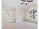 Bright bedroom features vaulted ceiling, large window, and attached bathroom with double sinks at 1928 Shadow Glen Dr, Raleigh, NC 27604