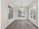 Bright dining area features hardwood floors, large windows, and a charming chandelier at 1928 Shadow Glen Dr, Raleigh, NC 27604